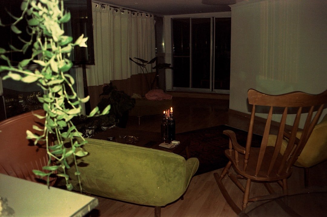 A dimly lit living room with a candle.