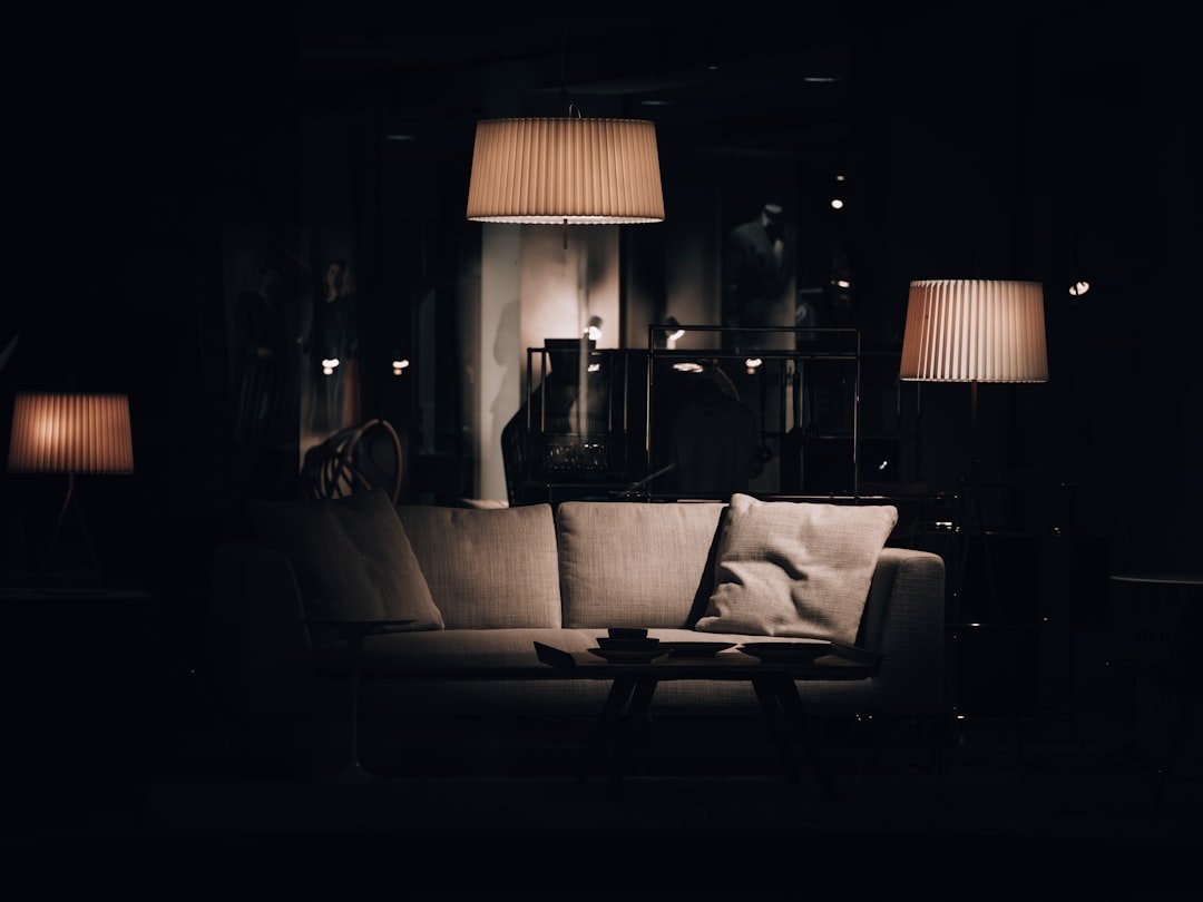 a living room with a couch and lamps