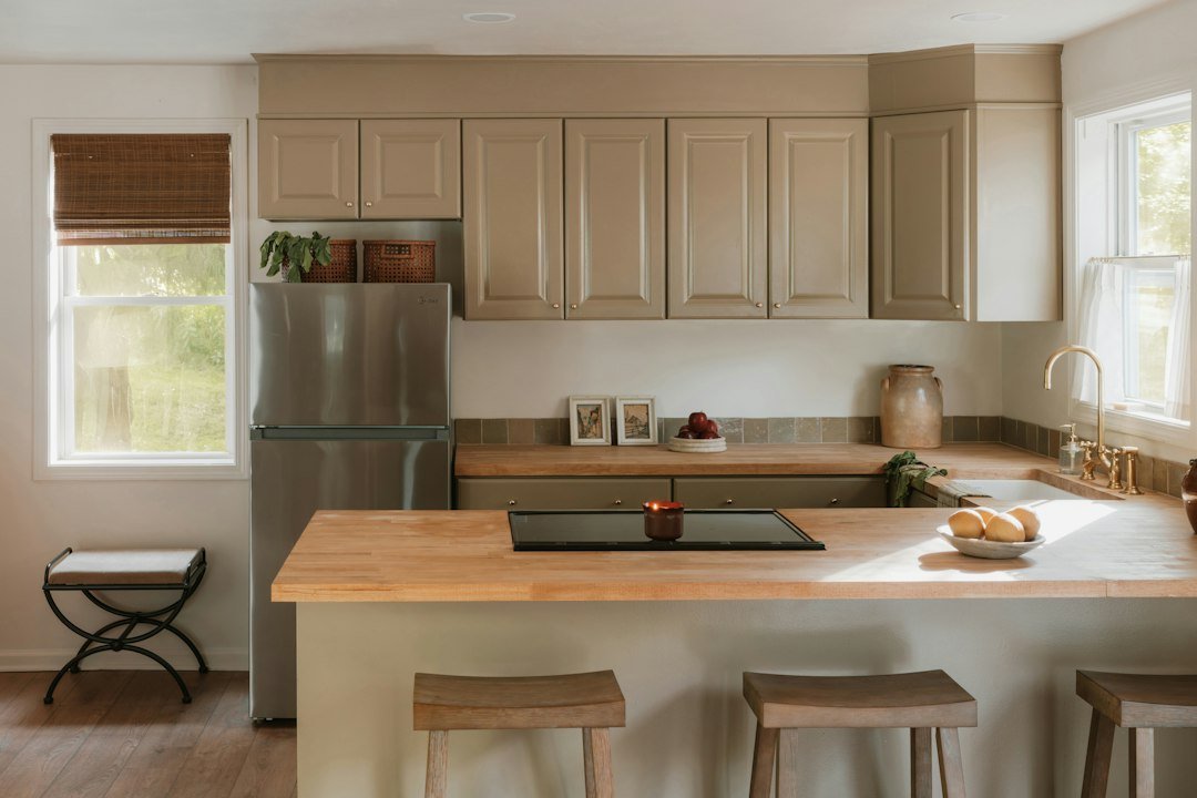A modern kitchen with light wood countertops and island