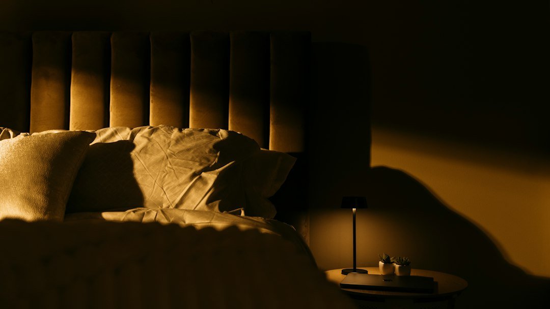 a bedroom with a bed and a night stand